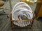 GARDEN HOSE AND CARRIER; WHITE GARDEN HOSE IN A BAMBOO CARRIER BASKET.