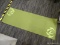 THIN YOGA MAT; SAGE GREEN YOGA MAT WITH LIGHT GREEN DESIGN. MEASURES 5 FT 7 IN X 2 FT.