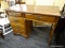 VINTAGE WOODEN DESK; CENTER DOVETAIL DRAWER ABOVE THE KNEE HOLE WITH 4 DOVETAIL DRAWERS TO THE LEFT.