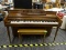 WHITNEY BY KIMBALL CONSOLE PIANO; WALNUT CASE PIANO WITH BUILT IN MUSIC STAND. SERIAL #313575.