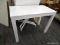 WHITE IKEA TABLE; RECTANGULAR TOP TABLE WITH SINGLE PULL OUT DRAWER SITTING ON 4 BLOCK LEGS.