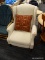 VINTAGE WINGBACK CHAIR; CREAM COLORED WINGBACK SIDE CHAIR WITH PAISLEY PATTERN, AND ROLLED ARMS.