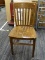 VINTAGE WOODEN SIDE CHAIR; VINTAGE SIDE CHAIR WITH SPINDLE BACK POSTS, ROUNDED SEAT, AND TAPERED