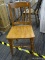 WOODEN SIDE CHAIR; VINTAGE WOODEN SIDE CHAIR WITH SLIGHT SADDLE SEAT. SITS ON FRONT SPINDLE LEGS.