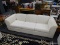 BAUHAUS SOFA; OFF WHITE COLORED SOFA WITH BLUE AND GREY PINSTRIPES. THIS THREE CUSHIONED SOFA HAS