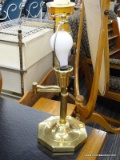 ADJUSTABLE ARM LAMP; BRASS LAMP WITH HOOP STYLE FINIAL, ADJUSTABLE ARM, AND A COLUMNAR STYLE BODY.