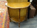 DEMILUNE HALL TABLE; HAS A PIE CRUST EDGE AND LOWER SHELF WITH TURNED LEGS. MEASURES 1 FT 11 IN X 12