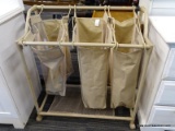 ROLLING LAUNDRY BASKET; HAS THREE SEPARATE BAGS HANGING ON A ROLLING FRAME. 2FT 10IN TALL X 2FT 6IN