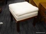 UPHOLSTERED STOOL; CREAM COLORED BUTTON TUFTED OVERSTUFFED CUSHION SITTING ON A WOOD BASE WITH 4