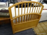 TWIN SIZE BED; OAK TWIN SIZE BED WITH RAIL STYLE BACK. NEEDS RAILS. MEASURES 3 FT 6 IN X 3 FT 7 IN