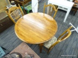 KITCHEN TABLE AND CHAIRS; ROUND WOODEN DROP LEAF TABLE (LEAF NOT INCLUDED) SITTING ON CURVED TAPERED