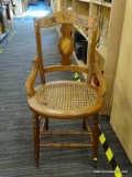 VINTAGE CANE SEAT SIDE CHAIR; TWO-TONED FIDDLE BACK SIDE CHAIR WITH ROUND CANE SEAT. SITS ON SPINDLE