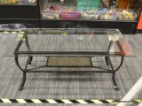 GLASS TOP COFFEE TABLE; SQUARE BEVELED GLASS TOP SITTING ON A BLACK METAL BASE WITH A MARBLED-LOOK