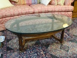 (LR) COFFEE TABLE- OVAL WALNUT AND GLASS TOP TABLE WITH STRETCHER BASE- 45 IN X 30 IN X 16.5 IN