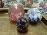 (LR) PAPERWEIGHTS; 3 GLASS PAPERWEIGHTS- 2 FLORAL ART GLASS- 3 IN AND 4 IN AND AN ART GLASS SWIRLED