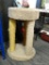 CAT TREE; TAN CARPETED CAT TREE/SCRATCHING POST WITH STURDY WOOD FRAME. HAS ONE WOOD POST, ONE POST