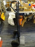 STEEL HAND TRUCK; BLACK HAND TRUCK WITH ROUNDED HANDLE ON BACK. MEASURES 4 FT 3 IN TALL.
