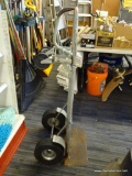 FOUR WHEEL HAND TRUCK; GREY STEEL 4 WHEEL-2 WAY HAND TRUCK WITH ROUNDED BACK HANDLE. MEASURES 4 FT 2