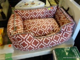 PLAY PET BED. RED AND WHITE PATTERNED SOFT PET BED FOR SMALL CAT OR DOG. MEASURES 1 FT 8 IN X 1 FT 2
