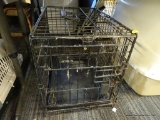 FOUR PAWS DOG CAGE; BLACK METAL FOUR PAWS K-9 KEEPER PORTABLE SMALL DOG CAGE. HAS TOP HANDLE AND