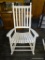 OUTDOOR ROCKING CHAIR; WHITE WOODGRAIN OUTDOOR PORCH ROCKING CHAIR WITH BANNISTER BACKS. MEASURES 31