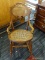 WOODEN ROCKING CHAIR; WOODEN ROCKING CHAIR WITH A WOVEN SEAT AND BACK. HAS SCROLL DETAILING ON THE