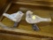 PAIR OF WOODEN BIRDS; 2 WOODEN BIRDS STANDING ON A LOG, ONE IS LOOKING FORWARD, OTHER IS LOOKING