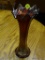 CARNIVAL GLASS VASE; RED/PURPLE CARNIVAL GLASS VASE WITH SCALLOPED TOP. MEASURES 10.25 IN TALL.
