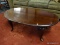 WOOD COFFEE TABLE; RICH MAHOGANY COLORED OVAL COFFEE TABLE SITTING ON 4 QUEEN ANNE LEGS. MEASURES 3