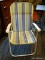 FOLDING BEACH CHAIR; CREAM AND BLUE STRIPED FOLDING BEACH CHAIR. MEASURES 1 FT 10 IN X 1 FT 6 IN X 2