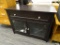 WOODEN ENTERTAINMENT STAND; BACK FACTORY PAINTED WOOD TV STAND. HAS AN UPPER DRAWER WITH 3 SECTIONED