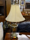 METAL TABLE LAMP; METAL LEAF DETAILED TABLE LAMP WITH CABRIOLE CLAW FEET. COMES WITH A BEIGE BELL