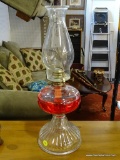 LARGE OIL LAMP; LARGE OIL LAMP WITH A CHIMNEY. COMES WITH A RED COLORED OIL. MEASURES 18 IN TALL.