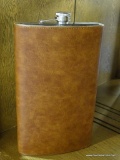 GIANT FLASK; GIANT METAL LEATHER FLASK. MEASURES 11 IN TALL.