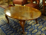 MAHOGANY COFFEE TABLE; OVAL COFFEE TABLE WITH SCALLOPED EDGES. SITS ON 4 CABRIOLE LEGS. MEASURES 3