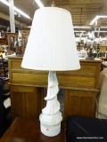 ONE OF A PAIR OF TABLE LAMPS; WHITE CURLING DRAPE TABLE LAMP WITH A TALL BRASS FINIAL , PLEATED