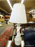 ONE OF A PAIR OF TABLE LAMPS; WHITE CURLING DRAPE TABLE LAMP WITH A TALL BRASS FINIAL , PLEATED