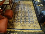 BOKHARA AREA RUG; BLUE AND TAN PATTERNED BOKHARA RUG. MEASURES 7 FT 5 IN X 5 FT 3 IN.