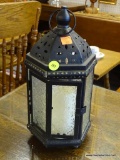 METAL LANTERN WITH CANDLE; BLACK METAL LANTERN WITH FLORAL PATTERNED GLASS PANELS. DOOR OPENS UP TO