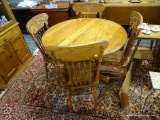 WALNUT DROP LEAF DINING SET; ROUND TOP WALNUT TABLE TOP WITH PEDESTAL BASE AND SINGLE DROP LEAF.