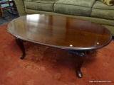 WOOD COFFEE TABLE; RICH MAHOGANY COLORED OVAL COFFEE TABLE SITTING ON 4 QUEEN ANNE LEGS. MEASURES 3