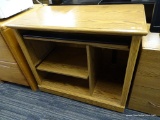 WOOD DESK; WOODEN DESK WITH A ROUND EDGED TOP WITH A ROLLING TABLE BELOW THE TOP, A SLIM COMPARTMENT