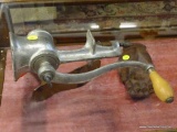 ANTIQUE METAL MEAT GRINDER; COUNTER ATTACHING METAL MEAT GRINDER. HAS A CRANK WITH A WOODEN HANDLE.