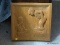 (UPBED) CARVED WALL PLAQUE; WOODEN CARVED WALL PLAQUE OF A BOY AND GIRL SIGNED LUIV- 14 IN X 15 IN