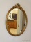 (FOYER) MIRROR; GOLD OVAL FLORAL RIBBONED MIRROR- 17.5 IN X 24 IN