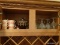 (KIT) CABINET LOT; LOT INCLUDES RED TRANSFERWARE TEA CUPS, A BLACK TEA POT WITH APPLIED DESIGNS, AND