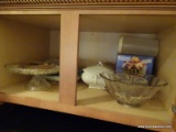(KIT) CABINET LOT; CABINET ABOVE THE FRIDGE. LOT INCLUDES A FOOTED CAKE PLATE, GLASS SERVING