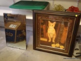 (GARAGE) FRAMED CAT PRINT; PRINT SHOWS A CAT SITTING AMONG BOOKS ON A SHELF. FRAMED IN A BROWN