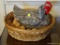 (DR) CHICKEN IN A BASKET; LARGE PORCELAIN CHICKEN WITH 8 EGGS IN A NESTED WOVEN BASKET. MEASURES 16