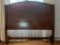 (DR) WOODEN HEADBOARD; MAHOGANY HEADBOARD WITH A DIAMOND SHAPED DARK WOOD DETAILING IN THE MIDDLE.